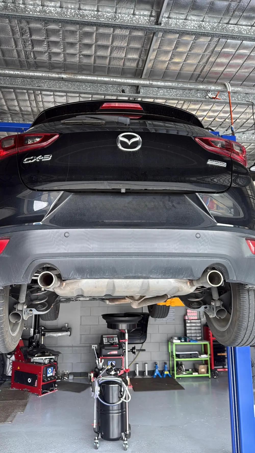 Car raised on a hoist for servicing